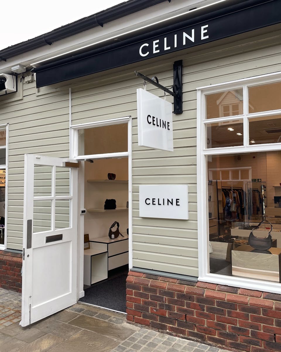 Chic Celine boutique facade with open entrance and stylish display in England.