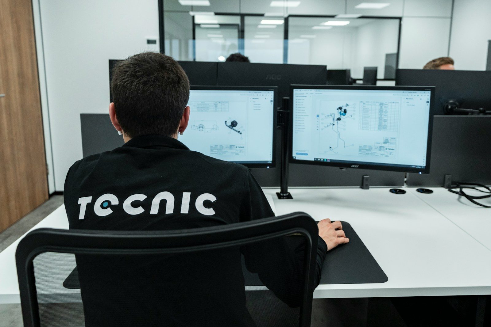 A person works on a computer in an office.